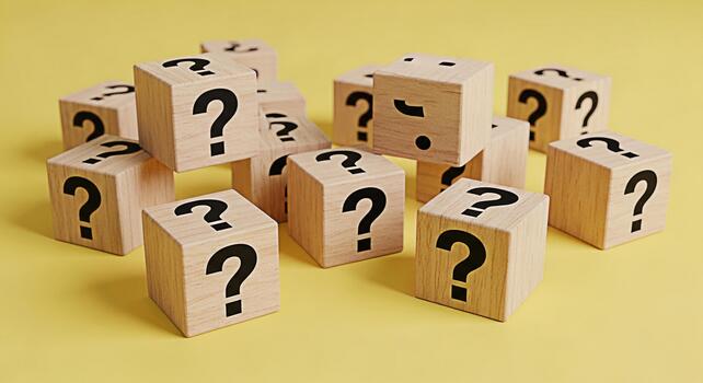 Wooden cubes displaying question marks scattered on a yellow surface representing uncertainty inquiry and the search for answers in a bright and minimalist setting evoking curiosity and problemsolving photo