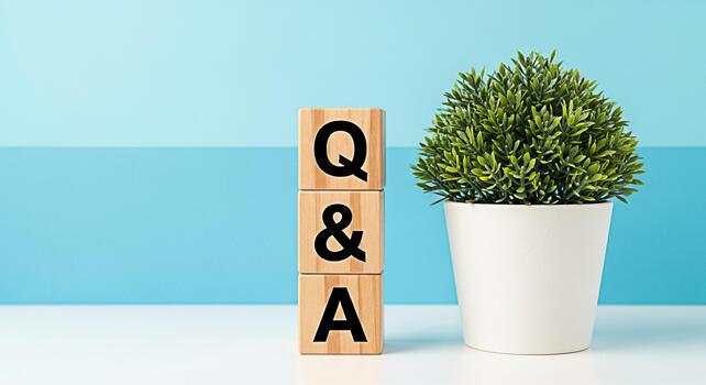 Wooden blocks displaying QA on a white table with a green plant against a twotone blue background representing questions and answers knowledge sharing and problemsolving in a bright and clean environm photo