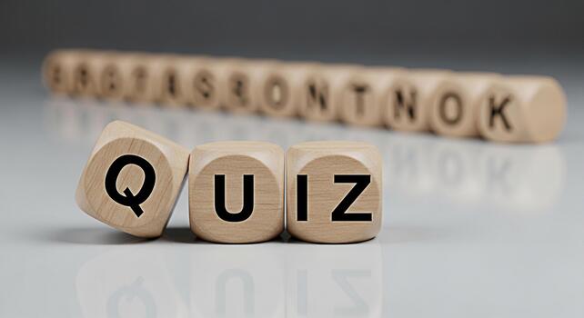 Wooden blocks spelling QUIZ on a reflective surface creating a playful and engaging atmosphere perfect for educational games trivia nights and interactive learning experiences promoting knowledge and photo