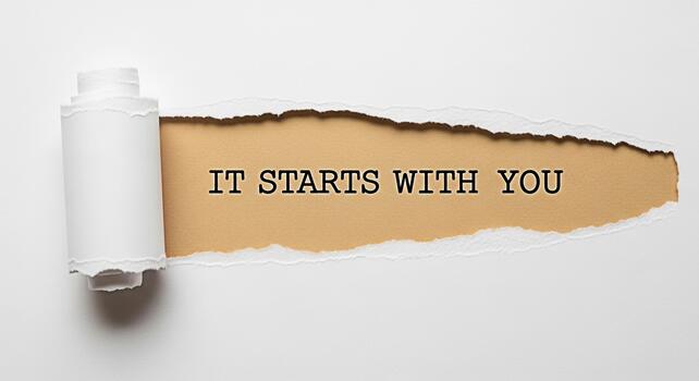 Torn paper revealing a message of empowerment on a beige background emphasizing personal growth and selfimprovement creating a motivational and inspiring atmosphere for positive change photo