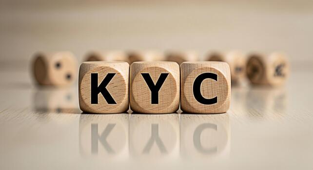 Wooden blocks displaying KYC on a bright surface representing the importance of Know Your Customer compliance in a modern business environment ensuring trust and security in financial transactions photo