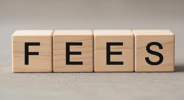 Wooden blocks spelling FEES on a textured surface representing financial obligations and costs conveying a sense of responsibility and the importance of understanding expenses in a business context photo