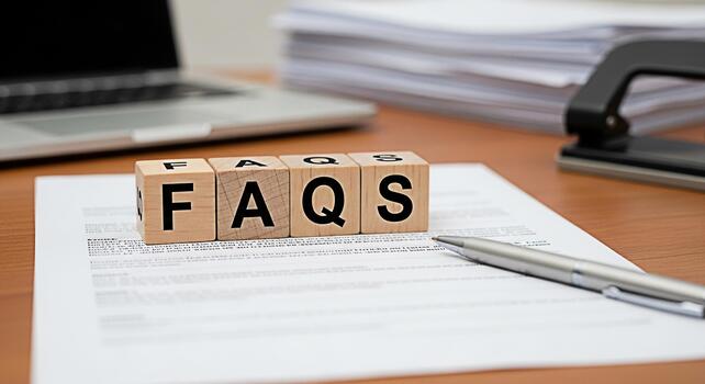 Wooden blocks spelling FAQs on a desk with a laptop and documents representing information and support for customers creating a helpful and informative atmosphere in a business setting photo