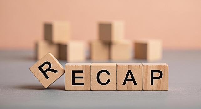 Wooden blocks spelling RECAP on a gray surface symbolizing a summary or review in a business or educational setting conveying a sense of reflection and analysis of past events and achievements photo