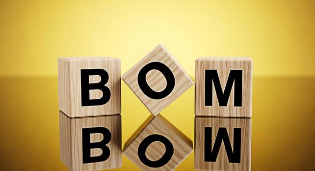 Wooden blocks spelling BOM on a reflective surface against a golden background symbolizing a creative and playful approach to language and wordplay perfect for educational or designrelated projects photo