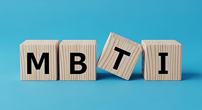 Wooden blocks displaying MBTI on a blue surface representing personality assessment and psychological type theory in a bright and clean studio setting conveying a sense of clarity and understanding photo