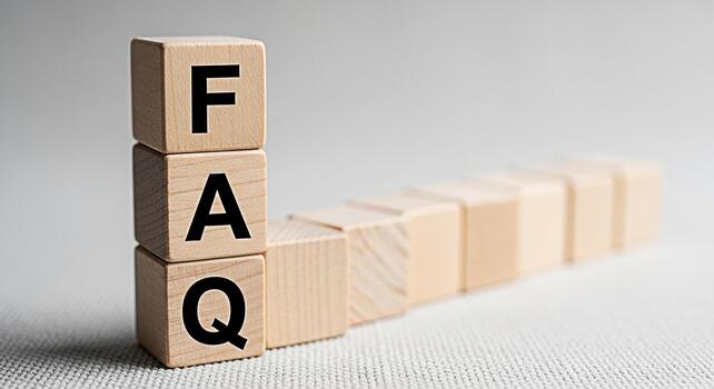 Wooden blocks displaying FAQ in a bright studio setting representing frequently asked questions and knowledge base resources promoting clarity and customer support for online services and information photo