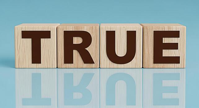 Wooden blocks spelling TRUE on a reflective surface against a blue background symbolizing honesty integrity and the importance of truthfulness in communication and relationships photo