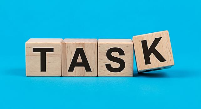 Wooden blocks spelling TASK on a vibrant blue surface representing a challenge or assignment symbolizing focus and determination in achieving goals with a clear and concise message photo