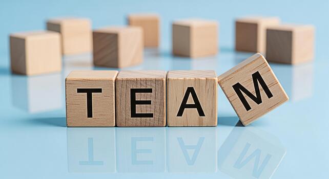 Wooden blocks spelling TEAM on a reflective surface symbolizing collaboration and unity in a bright modern setting conveying a sense of teamwork and success in business and organizational environments photo