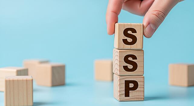 Hand placing a wooden block with the letter S on top of other blocks spelling SSP on a blue surface representing a Supply Side Platform in a business and technology context conveying growth and strate photo