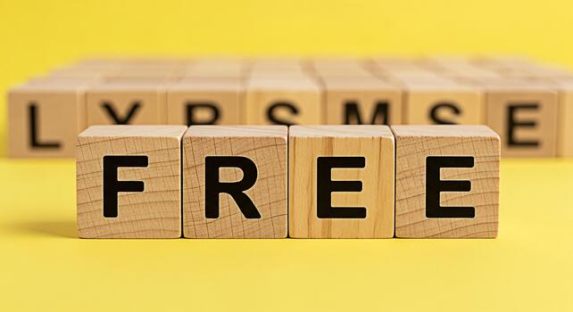 Wooden blocks spelling FREE on a bright yellow background representing opportunity and accessibility symbolizing a promotional offer and a sense of liberation and open access to resources and informat photo
