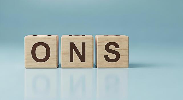 Wooden blocks displaying the word ONS on a light blue surface representing statistics and data analysis in a clean minimalist setting conveying a sense of clarity and precision photo
