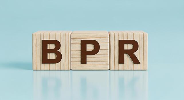 Wooden blocks displaying BPR on a light blue surface representing Business Process Reengineering in a minimalist and clean environment symbolizing efficiency and strategic improvement photo