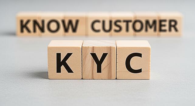 Wooden blocks displaying KYC and Know Customer on a gray surface representing the importance of customer identification and compliance in a business setting conveying trust and security photo