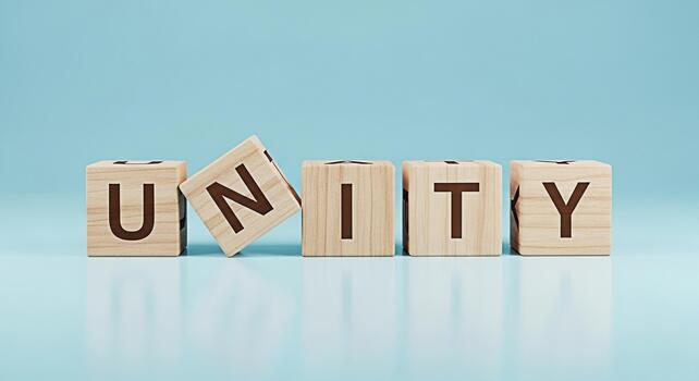 Wooden blocks spelling UNITY on a light blue surface symbolizing collaboration and teamwork in a bright and optimistic setting promoting a sense of togetherness and shared purpose for a harmonious fut photo
