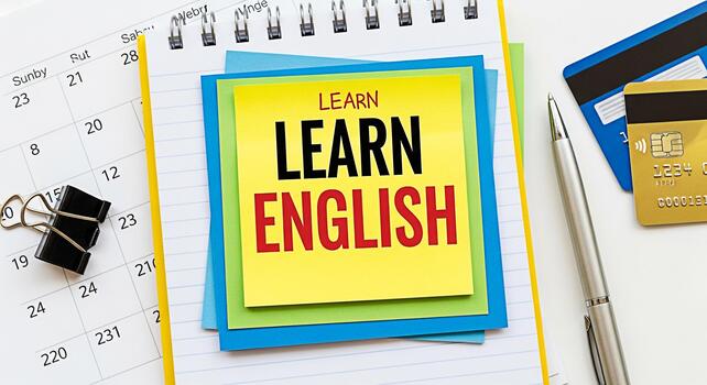 Closeup of colorful sticky notes with Learn English text on a calendar and notebook representing language learning financial planning and educational goals in a modern organized workspace photo