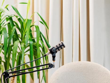 Podcast setup features microphone and camera for engaging interview experience in a modern clean space photo