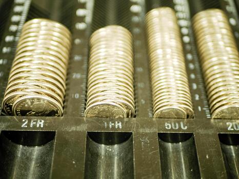 Neatly arranged rolls of coins placed in designated slots of a cash register drawer showing currency organization and structured financial handling in retail Prof Photo