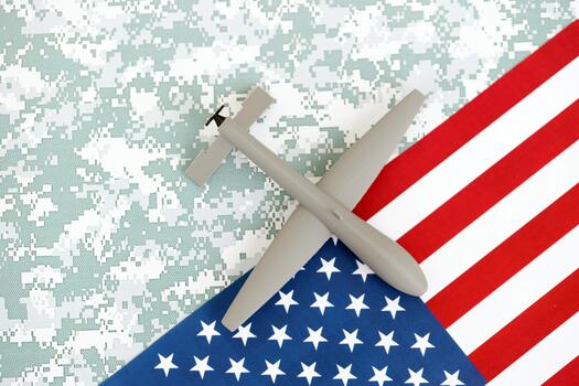 Drone unmanned autonomous technology of espionage and strikes on the enemy. Toy uav drone on flag photo