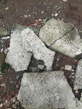 Macro photography of a broken concrete surface with natural crack patterns and a rough texture, in natural light. Used for AI learning texture recognition. photo