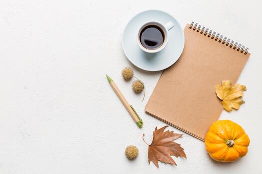 Autumn composition fallen leaves and craft sketchbook mock up on colored background. Flat lay with copy space photo