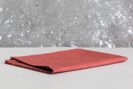 top view with red empty kitchen napkin isolated on table . Folded cloth for mockup with copy space, Flat lay. Minimal style photo