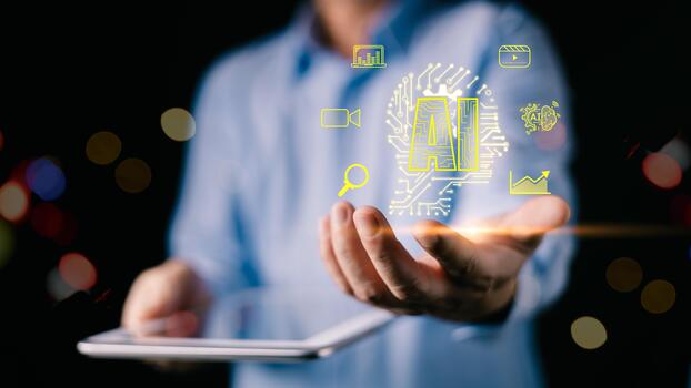 A man in a blue shirt holds a tablet while projecting glowing yellow AI icons, symbolizing digital innovation, data analysis, and futuristic technology.A dark bokeh background enhances contrast. photo