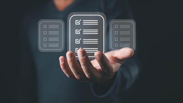 A person holds a digital interface displaying three floating icons representing a checklist document with checkboxes and lines, symbolizing digital tasks, workflow, and organization efficiency. photo