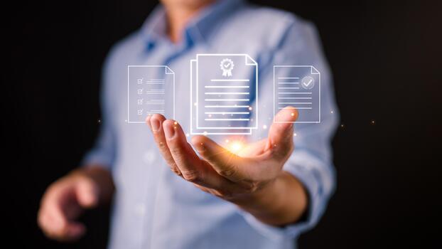 A businessman holds glowing digital document icons, representing certification, compliance, digital records, quality assurance, verified documentation, and modern data management systems. photo