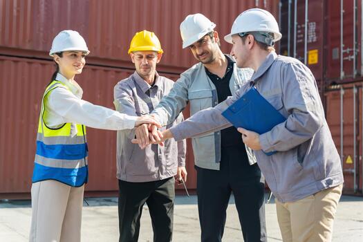 Group of Warehouse Workers Celebrating Teamwork and Achievement at Cargo Port, Industrial Engineers Stacking Hands, Diverse Logistics Team Showing Unity and Partnership in Container Yard photo