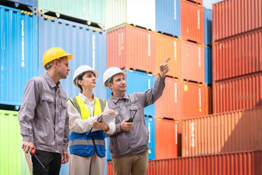 Diverse Logistics Team Inspecting and Pointing to Shipping Containers at Port Terminal, Engineers Planning Cargo Stacking and Inventory Management in the Yard, Supervisor Directing Work Flow photo