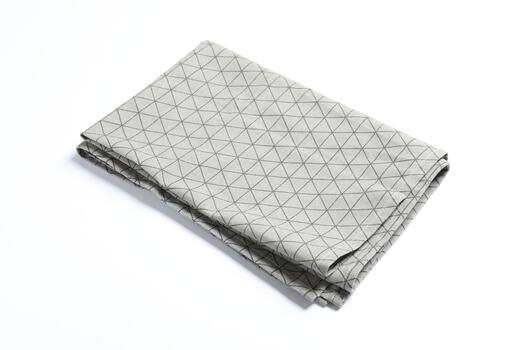 A folded gray and white towel with a geometric pattern photo
