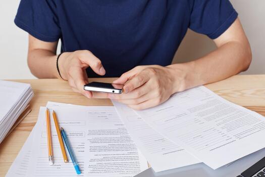 recortado imagen de inteligente teléfono en mans manos. ocupado masculino emprendedor se sienta a trabajo lugar, usos moderno móvil teléfono para comunicación o surf social redes, usos gratis Internet conexión y Wifi foto