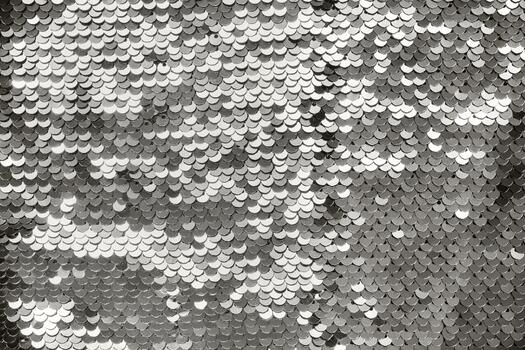 Close up of shiny silver sequins creating an abstract pattern. Color of the year concept photo