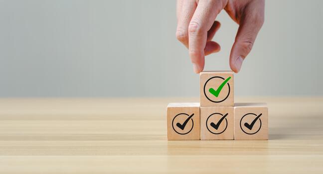 Checklist and quality assurance concept with wooden blocks stacked with check mark icons, symbolizing task completion, project approval, business standard, successful evaluation, process verification photo