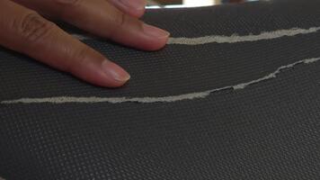 Close-up of a Hand Gently Touching a Black Surface with White Lines in a Textured Pattern for Abstract Art or Design video