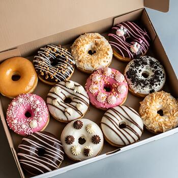 Chocolate Frosted Donuts With Sprinkles In White Box photo