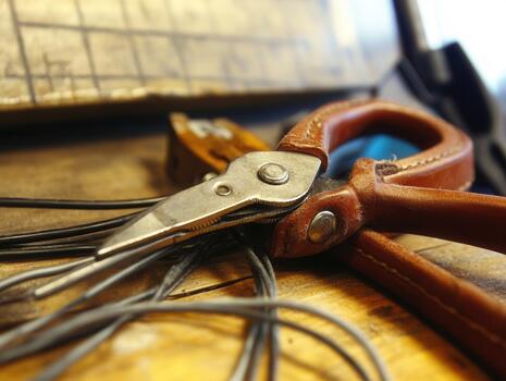 Close-up of electrician's tool belt showing essential tools and materials for wiring projects in a workshop setting during the day photo