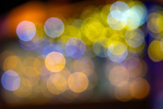 A mesmerizing bokeh effect with golden and multicolored lights on a dark background, ideal for holiday or dreamy compositions with a glow. photo