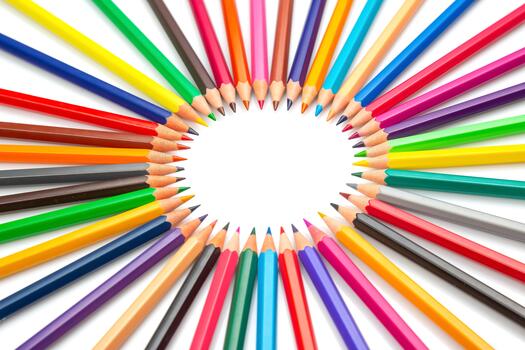 the Multicolored pencils arranged in a circular pattern against a white backdrop, forming a central frame. Ideal for artistic projects, school supplies, or creative design concepts. photo