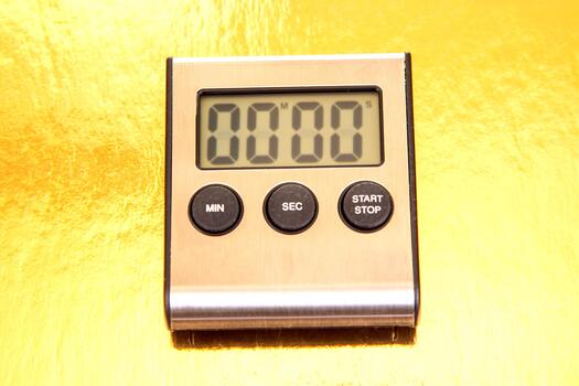the modern silver digital timer showing 00 00 against a vibrant yellow surface. Includes MIN, SEC, START, and STOP buttons. Perfect for culinary or productivity use. photo