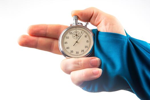 hand with a mechanical analog stopwatch on a white background. Time part precision. Measurement of the speed interval photo