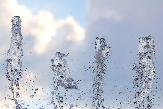 agua chorros crear dinámica patrones en contra un nublado cielo en un público fuente foto
