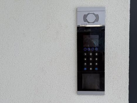 Entrance intercom with keypad. Security access, residential building control and modern communication technology. Copy space photo