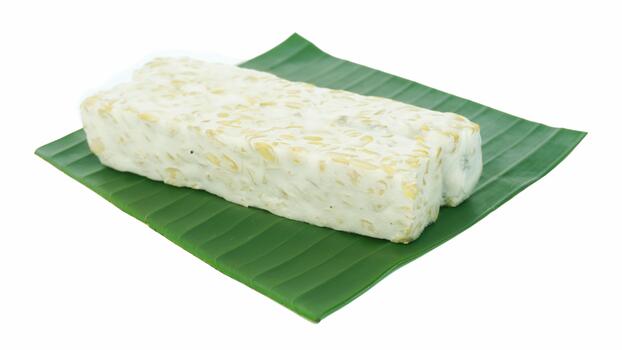 Tempeh or soybean tempeh, a source of vegetable protein made from soybeans that are boiled and given special yeast through a fermentation process until they form a solid on green banana leaves. photo