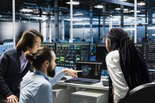 Server farm IT coworkers doing brainstorming, deploying AI tools to automate repetitive workflows. Data center technicians cooperating to manage datasets used in AI training, streamlining tasks photo