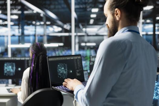 Software developer in data center using AI LLM assistant on laptop to perform maintenance on infrastructure rigs. Server hub IT expert using artificial intelligence large language model to do backups photo