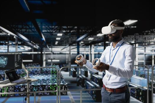 Server hub male programmer using virtual reality technology to simulate AI neural network systems. Young man in data center using VR goggles tools to oversee futuristic AI visualization. photo