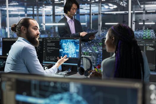 Manager and female programmer in server room using PC to review infrastructure diagnostics. IT specialist teaching trainee during internship in data center, analyzing performance data photo